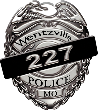 Wentzville Police Department badge #227 with a memorial mourning band