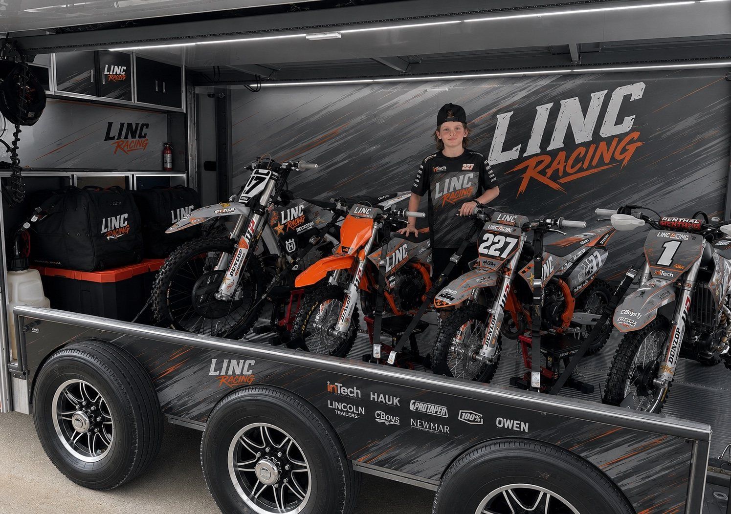 Lincoln Hauk with the full LINC Racing bike lineup inside the open inTech race trailer.
